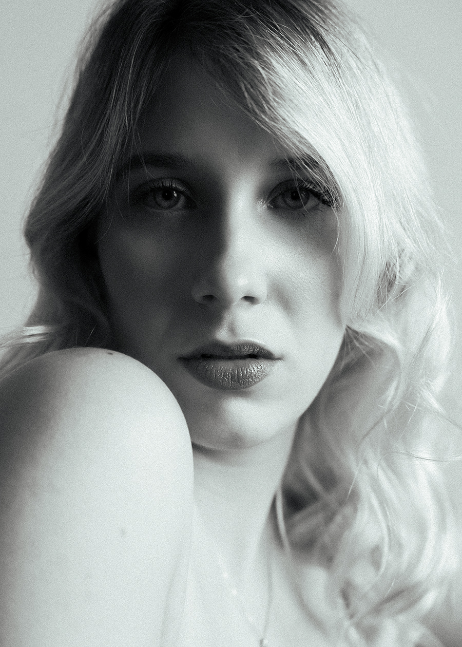 Black and white closeup of woman looking directly into camera